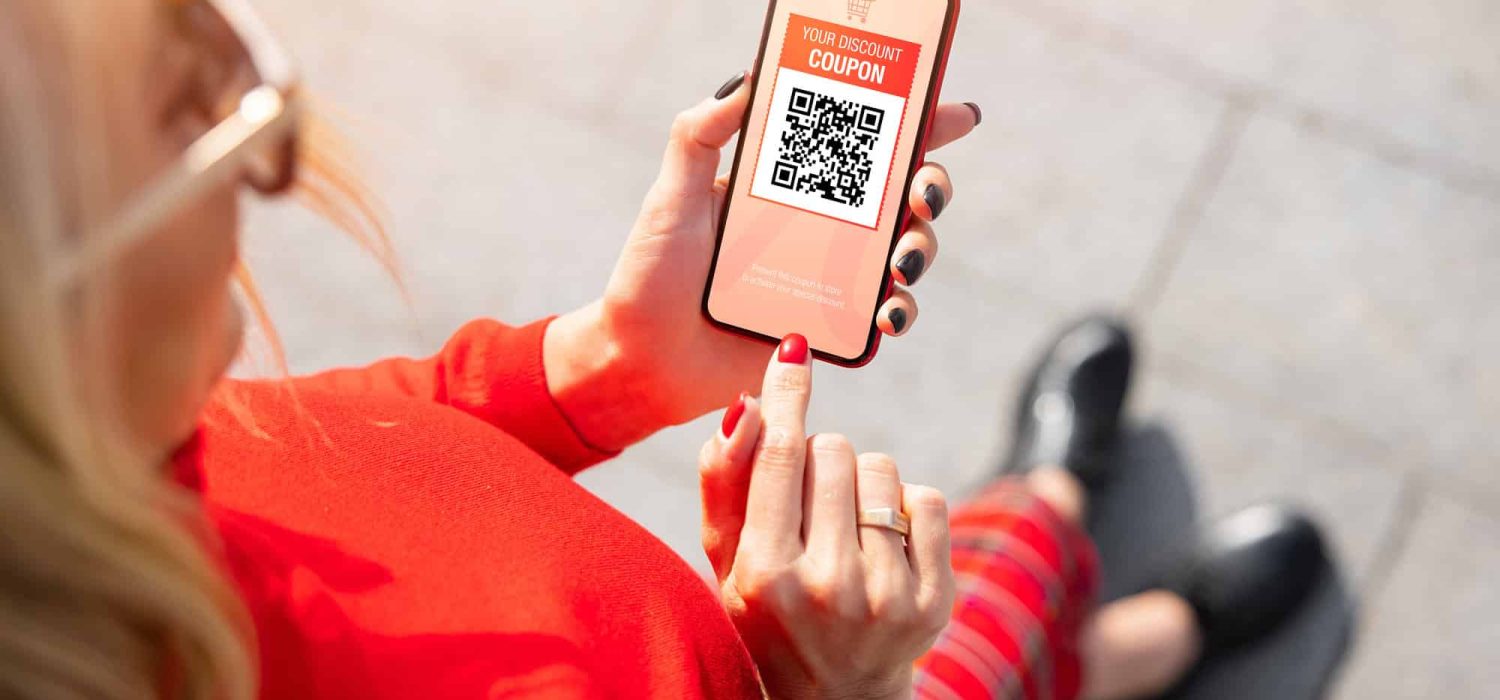 Woman viewing discount coupon on mobile phone